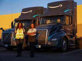 Bree Davis, gestionnaire de chauffeurs, et Ebony McKinley, partenaire de fret d'Amazon, posent pour un portrait près de la flotte de camions de Seven Strong Trucking à Phoenix, en Arizona.