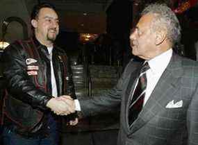 Le maire de Toronto, Mel Lastman, serre la main de Tony Biancafiore, membre du Hells Angel Motorcycle Club, alors qu'il sort de l'Holiday Inn sur King St. W. le vendredi 11 janvier 2002.