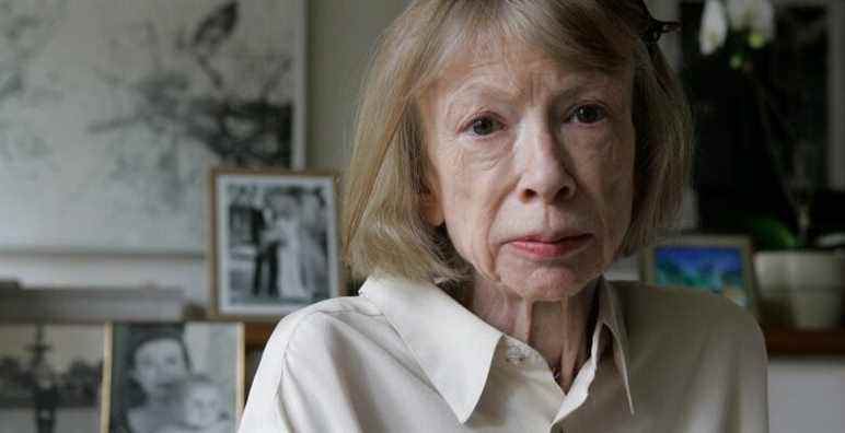 FILE - Author Joan Didion sits in front of a photo of herself holding her daughter, Quintana Roo, and another picture of her daughter's wedding, in her New York apartment Sept. 26, 2005. Didion, the revered author and essayist whose provocative social commentary and detached, methodical literary voice made her a uniquely clear-eyed critic of a uniquely turbulent time, has died. She was 87. (AP Photo/Kathy Willens, File)