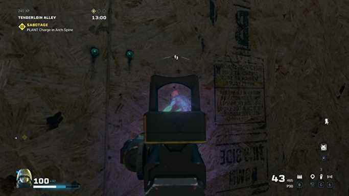 L'opérateur Rainbow Six Extraction scanne un grognement ennemi à travers un mur à l'aide d'une lumière UV