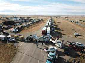 Un convoi de camions et d'autres véhicules bloque la circulation sur l'autoroute 4 près du poste frontalier de Coutts.