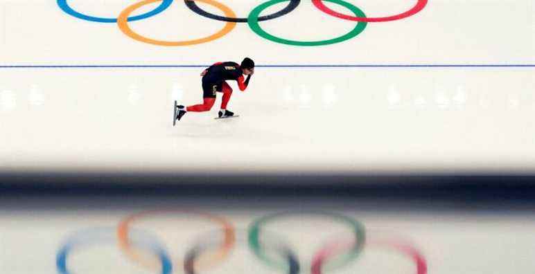 A Chinese athlete warms up before the start of the men's speedskating 1,500-meter race at the 2022 Winter Olympics, Tuesday, Feb. 8, 2022, in Beijing. (AP Photo/Ashley Landis)