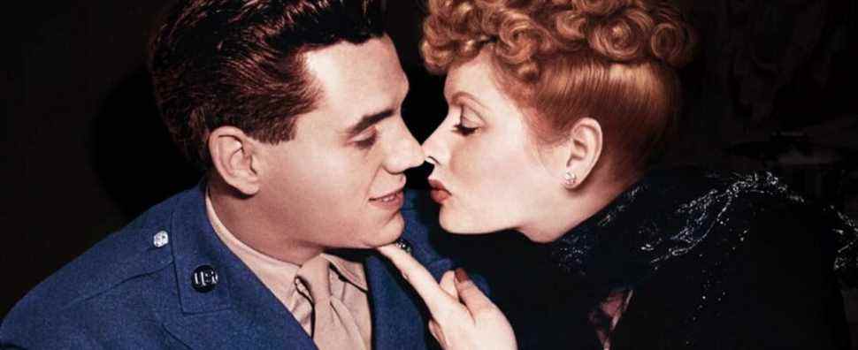 Lucille Ball puts a finger under the chin of Desi Arnaz, in color