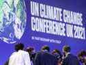 Les délégués parlent lors de la Conférence des Nations Unies sur les changements climatiques à Glasgow, en Écosse, le 13 novembre 2021. 
