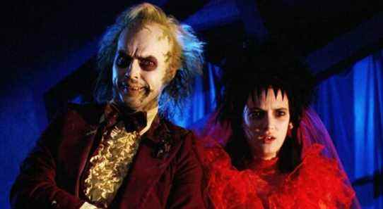 Winona Ryder in a red wedding dress next to Beetlejuice