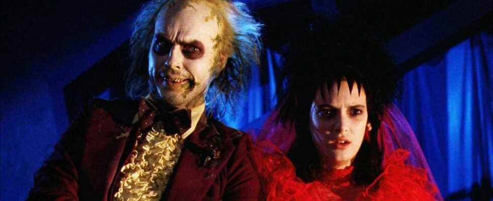 Winona Ryder in a red wedding dress next to Beetlejuice