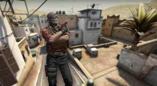 A CS:GO Terrorist showing his pistol with Dust 2 in the background