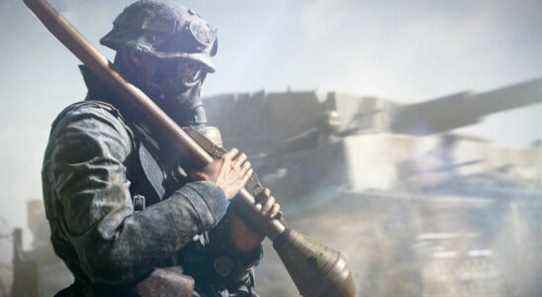 Assault class soldier holds a rocket while wearing a gas mask, with tank in background. From Battlefield 5