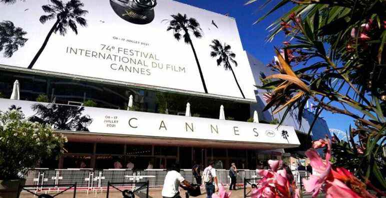 Members of the public walk in front of the Palais des Festival prior to the 74th international film festival, Cannes, southern France, July 5, 2021. The Cannes film festival runs from July 6 - July 17, 2021. (AP Photo/ Brynn Anderson)