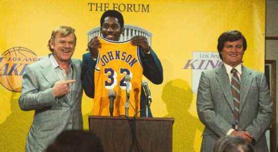 Magic holds up his new Lakers jersey at a press conference in Winning Time