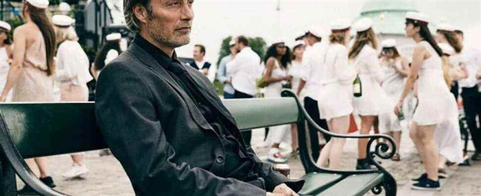Mads-Mikkelsen-In-Another-Round-Sitting-On-A-Bench