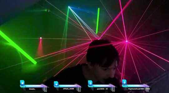 teenager crossmauz leans into his mic as lasers go off behind him
