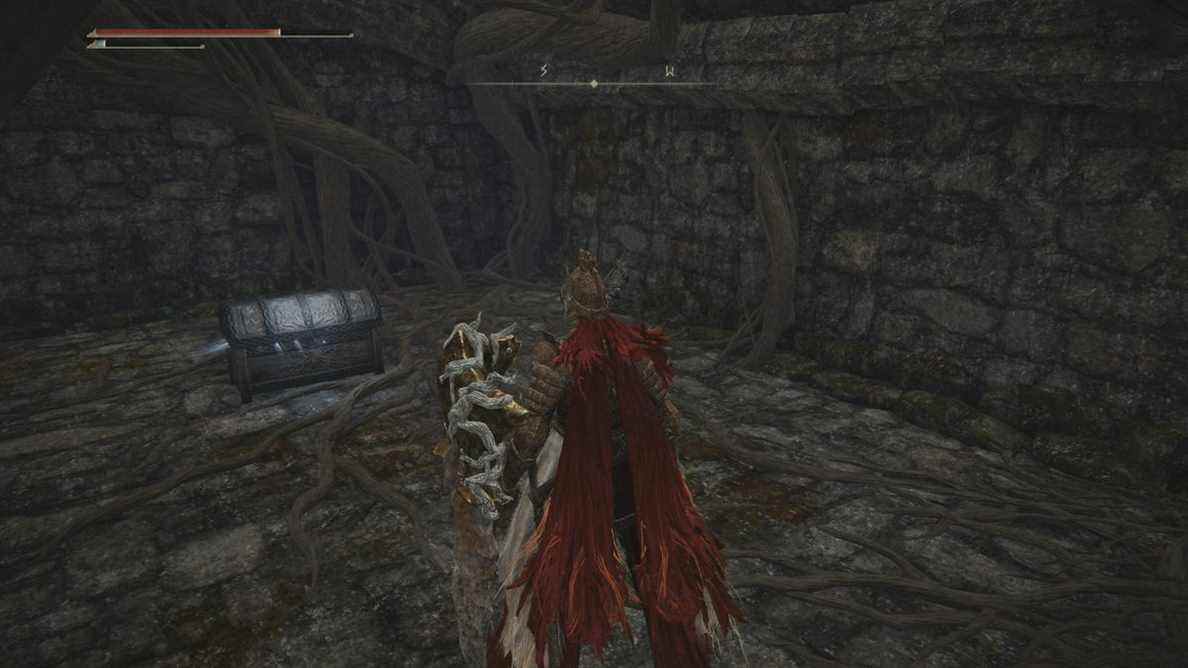 Joueur Elden Ring s'approchant d'un coffre contenant la Wraith Calling Bell dans une chambre souterraine