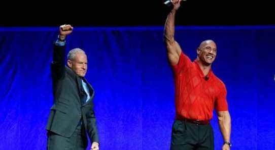 Toby Emmerich, left, chairman of the Warner Bros. Pictures Group, and Dwayne Johnson react to the audience after Emmerich handed Johnson the CinemaCon "Entertainment Icon of the Decade" award during the Warner Bros. Pictures presentation at CinemaCon 2022 at Caesars Palace, Tuesday, April 26, 2022, in Las Vegas. (AP Photo/Chris Pizzello)