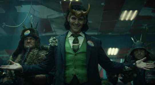 Tom Hiddleston dressed as President Loki with his arms splayed open wide.