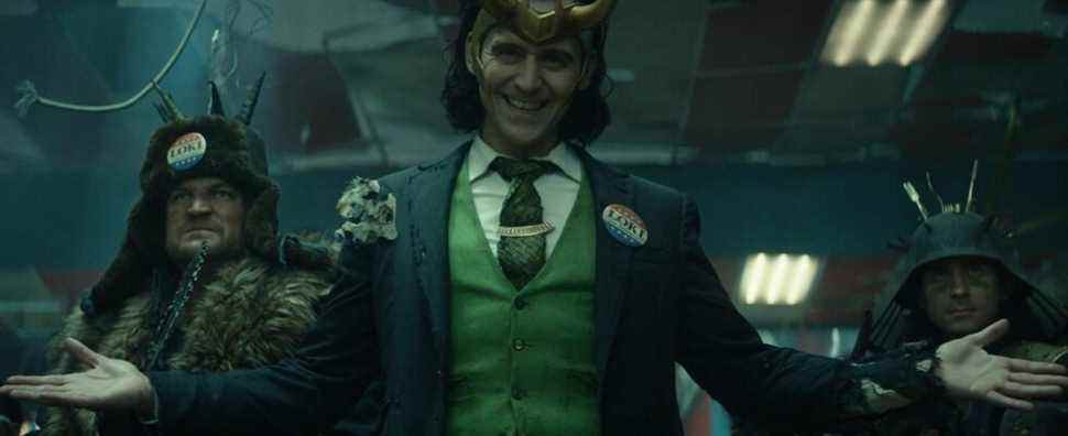 Tom Hiddleston dressed as President Loki with his arms splayed open wide.