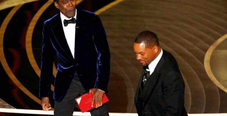 Presenter Chris Rock, left, reacts after Will Smith slapped him onstage during the 94th Academy Awards at the Dolby Theatre, Sunday, March 27, 2022, in Los Angeles. (AP Photo/Chris Pizzello)
