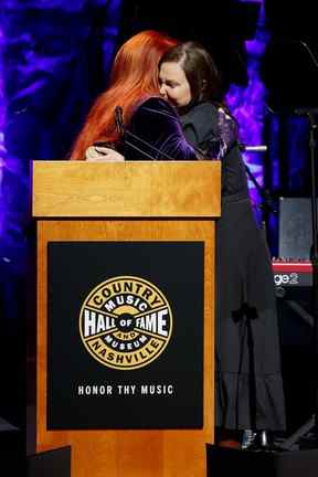 Les intronisées Wynonna Judd et Ashley Judd s'embrassent sur scène lors de la cérémonie de remise des médailles de la promotion 2021 au Country Music Hall of Fame and Museum de Nashville, le dimanche 1er mai 2022.