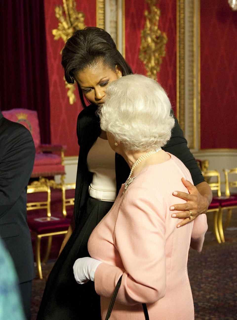 Michelle Obama met son bras autour de la reine lors d'une réception au palais de Buckingham, Londres, 2009. (Images PA)