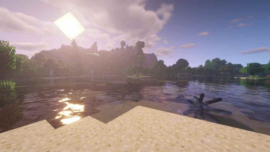 Meilleurs shaders Minecraft : Le mod BSL montrant une rive de lac pendant un coucher de soleil.  Le soleil fait scintiller le lac.