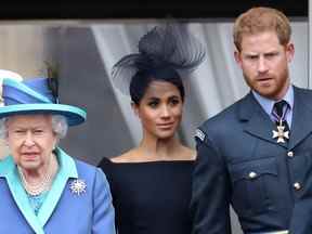 La reine Elizabeth II, le prince Harry, duc de Sussex et Meghan, duchesse de Sussex sur le balcon du palais de Buckingham alors que la famille royale assiste à des événements marquant le centenaire de la RAF le 10 juillet 2018 à Londres, en Angleterre.