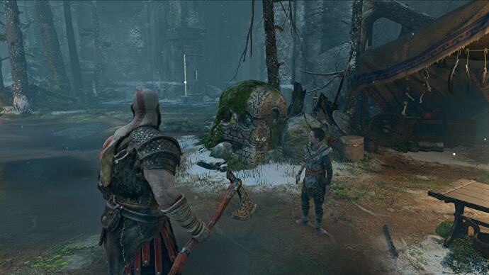 Kratos se tient devant une pierre en forme de crâne dans God of War.  Affiche la mise à l'échelle DLSS à 1440p.