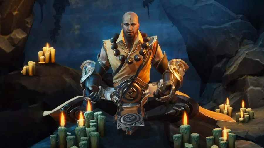 Liste des niveaux Diablo Immortal: le moine assis les jambes croisées devant de nombreuses bougies allumées