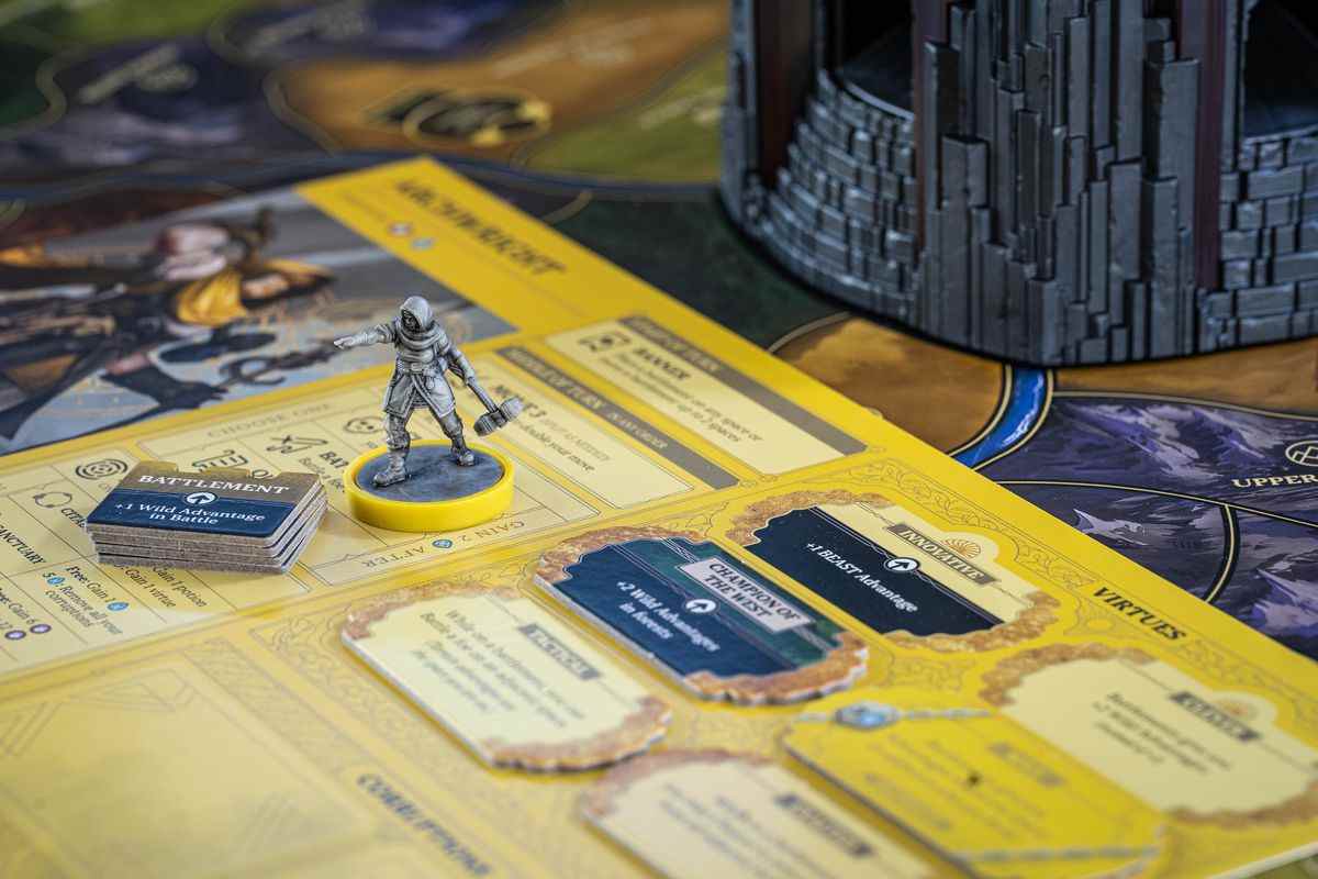 Un personnage joueur au sommet de son buffet, de couleur jaune pour correspondre à un anneau sur les figurines.
