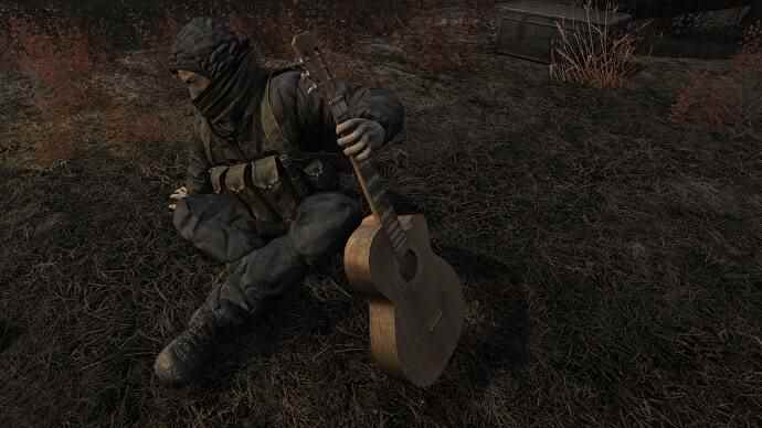 Le joueur regarde un PNJ assis par terre avec une guitare dans un mod de révision fait par un fan pour STALKER : L'ombre de Tchernobyl.