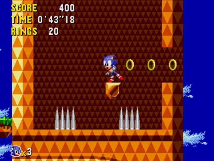 Un écran de Sonic CD, Sonic debout sur un petit rebord entre deux pièges à pointes