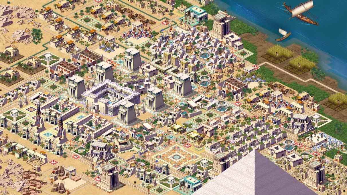 Une deuxième capture d'écran promotionnelle d'une ville dans Pharaoh: A New Era.  Cette ville est plus grande.  Les rives du Nil sont visibles dans le coin supérieur droit et la pointe d'une pyramide ressort du bas de la capture d'écran.