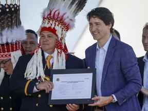 Le premier ministre Justin Trudeau, à droite, et le chef de la nation Siksika Ouray Crowfoot participent à une cérémonie de signature sur la nation Siksika à Siksika Nation, en Alberta, le jeudi 2 juin 2022. LA PRESSE CANADIENNE/Jeff McIntosh