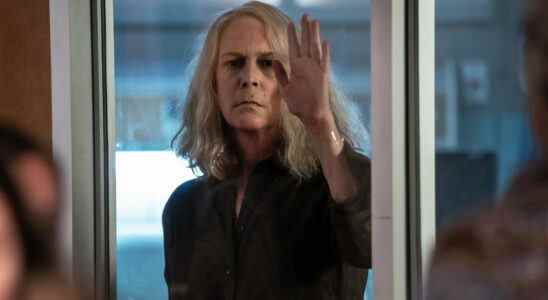 Jamie Lee Curtis in Halloween Kills with palm on glass wall