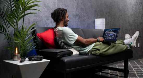 A man browsing JustGPU.com on a laptop
