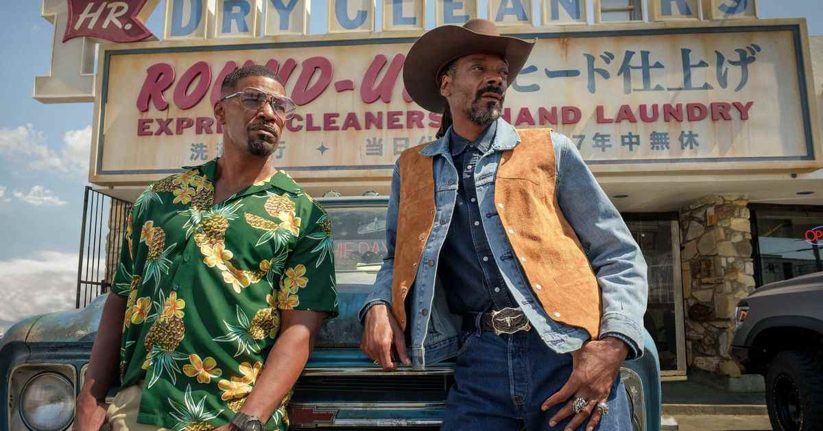 Jamie Foxx (en chemise hawaïenne) et Snoop Dogg (en chapeau et gilet de cow-boy) s'appuient contre un camion dans Day Shift