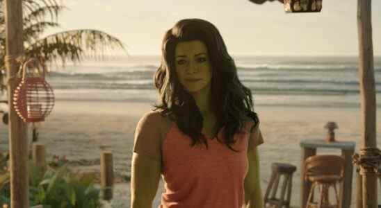 A tall woman with wavy black hair and green skin standing on a beach; still from "She-Hulk: Attorney at Law"