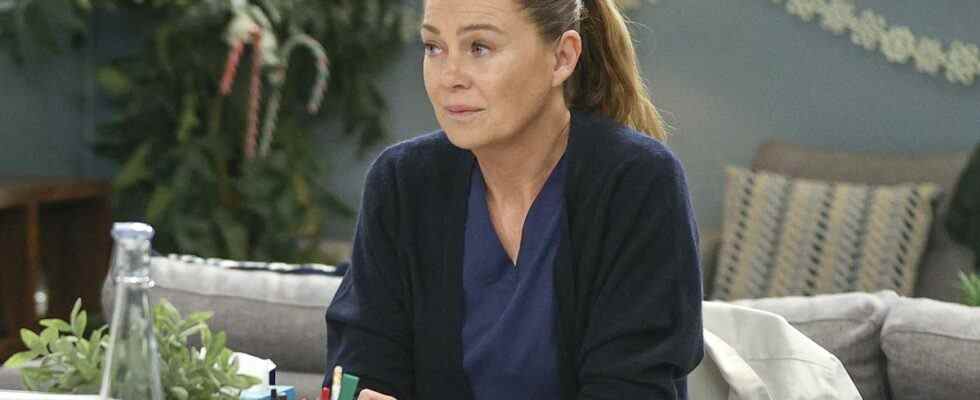 Meredith Grey sits at a desk on Grey
