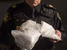 Un agent de la Police provinciale de l'Ontario montre des sacs contenant du fentanyl sur une photo d'archive.