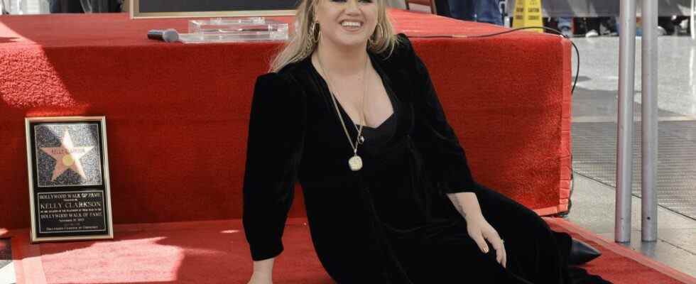 Kelly Clarkson is shown with her star on the Walk of Fame.