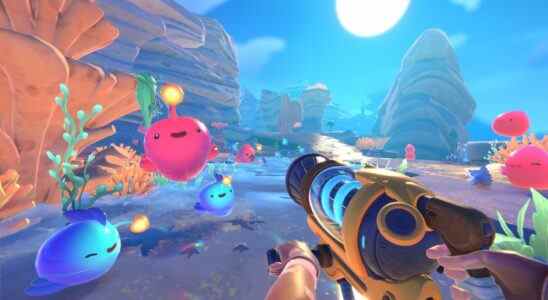 Blobs bouncing around in a colorful world while player points a vacuum tool at them