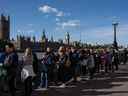 Les gens font la queue en face du palais de Westminster en attendant de rendre hommage à la reine Elizabeth II alors qu'elle se trouve en état à Westminster Hall le 17 septembre 2022 à Londres, au Royaume-Uni.  (Photo de Carl Court/Getty Images)