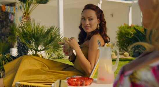 Olivia Wilde in a yellow dress holding a drink in Don