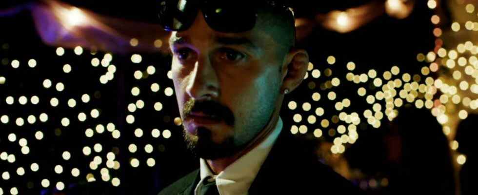 Shia LaBeouf looking worried in the middle of a party scene in The Tax Collector.