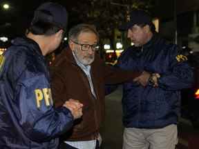 La police escorte Juan Percowicz pour qu'il purge sa détention provisoire à son domicile de Buenos Aires, Argentine, le 30 août 2022.