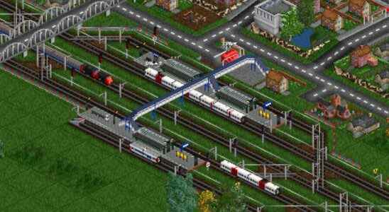 An image from transport game OpenTTD of trains and a village