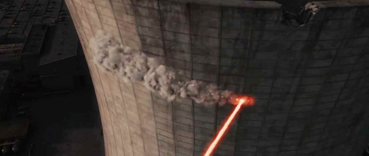 Les lasers toujours allumés de Deadpool tracent une ligne de destruction à travers le ciment de la cheminée de la centrale nucléaire dans X-Men Origins : Wolverine.