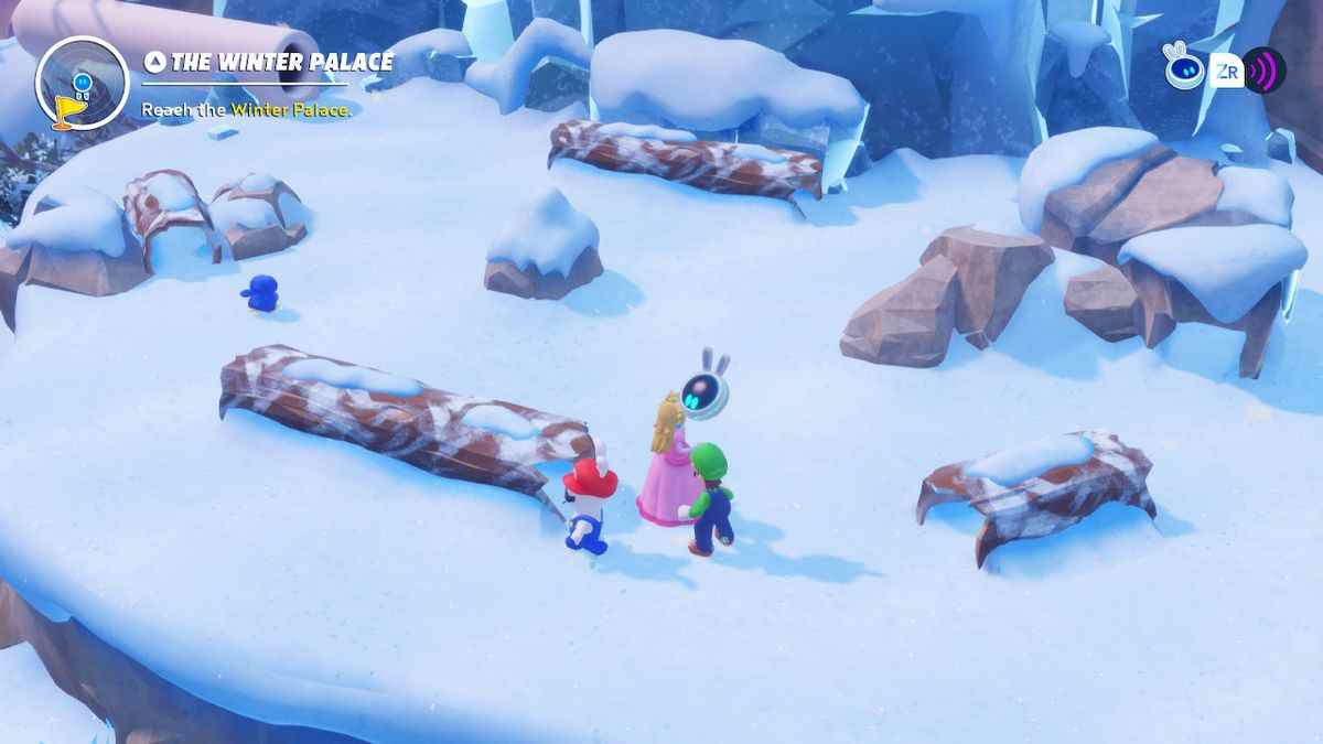 Peach, Luigi et Rabbid Mario chassent un pingouin bleu autour de bûches sacrées dans Mario + Rabbids Sparks of Hope