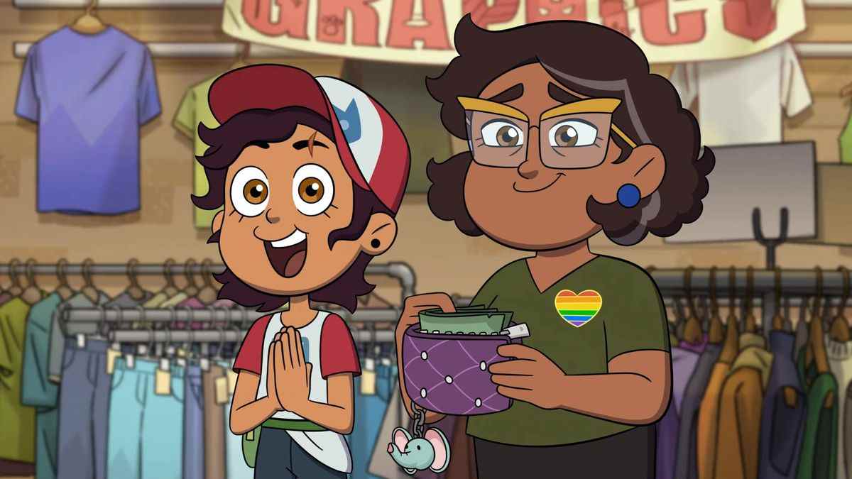 Luz et Camila debout dans une friperie ;  luz a l'air excité et camila porte un badge de fierté arc-en-ciel