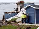 Le maire de Port aux Basques, Brian Button, s'entretient avec deux personnes dont la maison a été endommagée après l'arrivée de l'ouragan Fiona à Port Aux Basques, Terre-Neuve, Canada le 25 septembre 2022.
