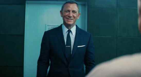 Daniel Craig smiles while laughing in an interrogation in No Time To Die.